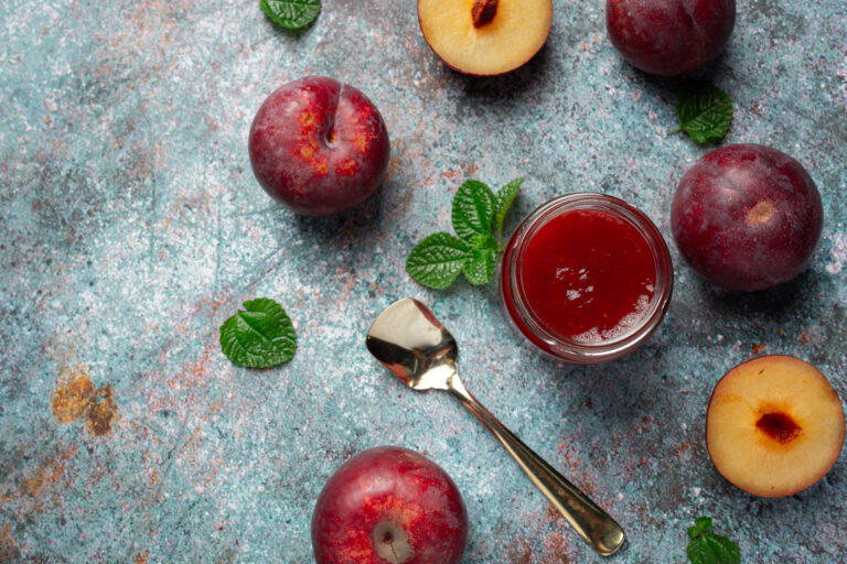 a bottle of plum jam  put on dark floor